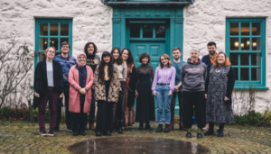 A group of people standing in front of a house