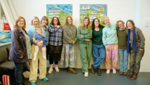 A group of people standing in front of artwork